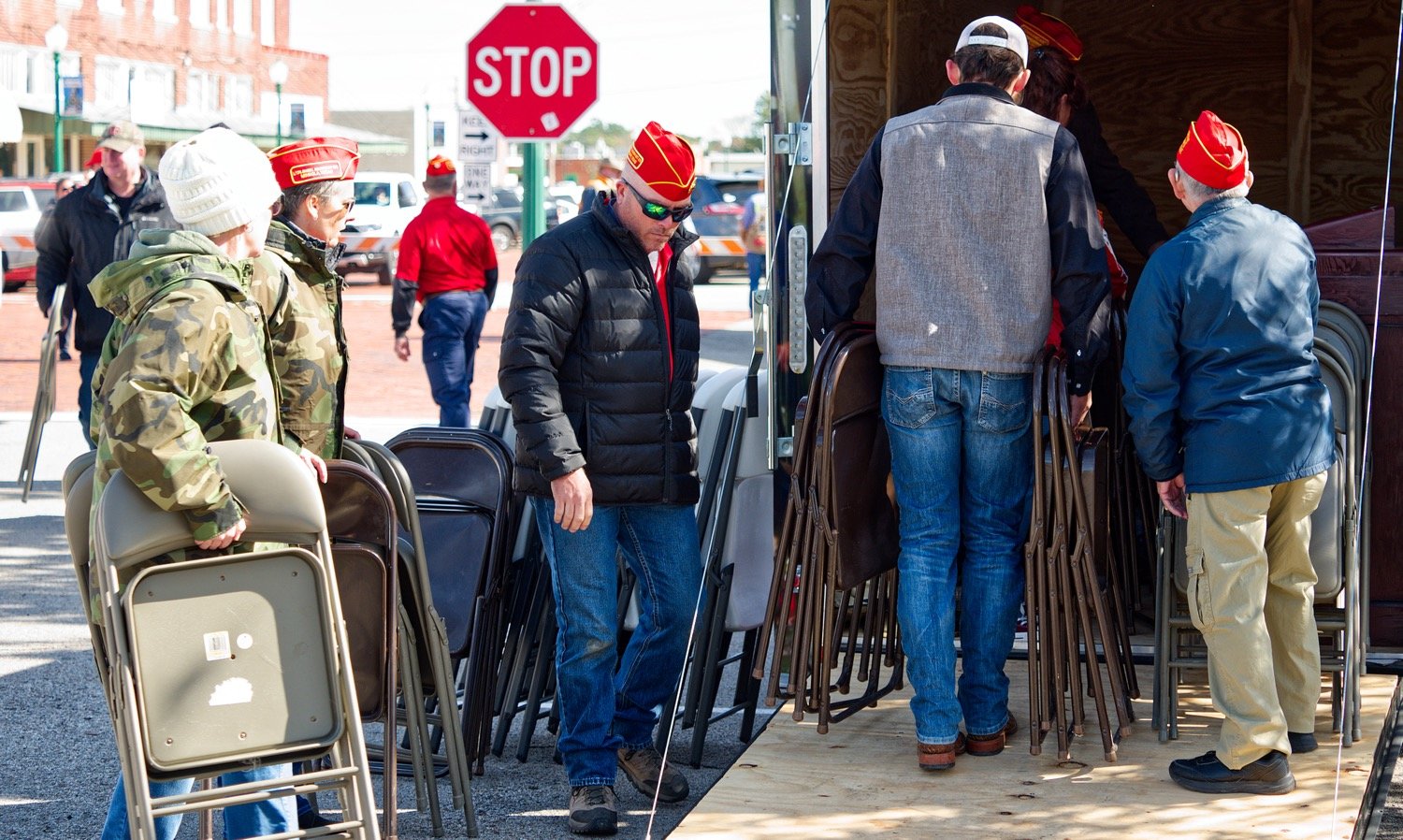 Following the ceremony, several Marine Corp League members along with a few others exhibit a servant’s heart by using many hands to make light work of packing the folding chairs put out for onlookers back into a trailer. [view more vets]